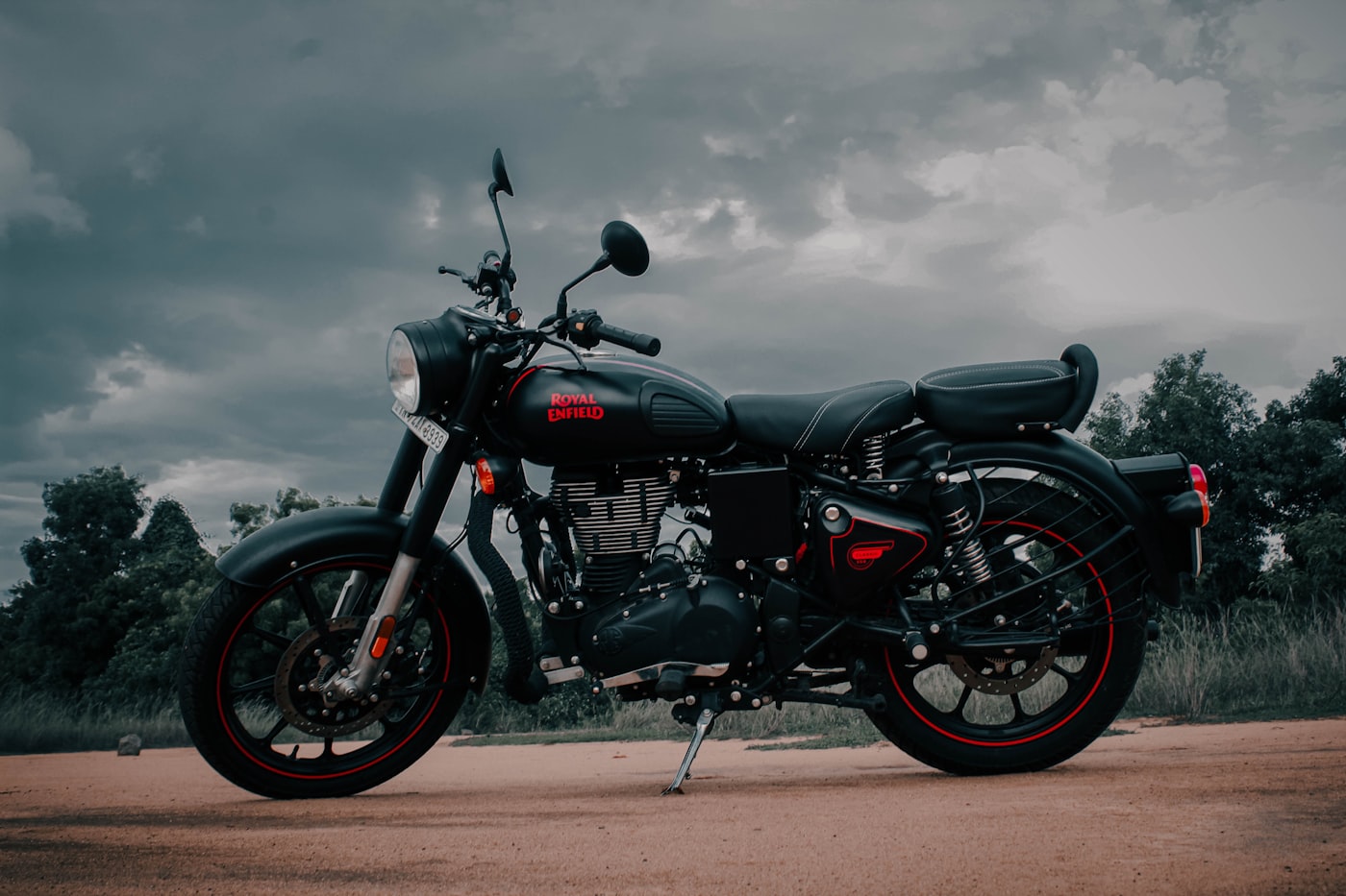 Black motorcycle with red accents against dramatic clouds